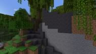 A cliff with a hidden entrance to a secret Minecraft base (Image via Mojang)